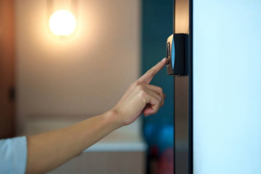 Close-up of a person's hand pressing a doorbell button beside a front door